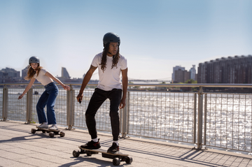 two people riding electric skateboard